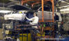 Working with exacting detail, a Dearborn Assembly worker adds his touch to a 2004 Ford Mustang at the historic Dearborn Assembly Plant